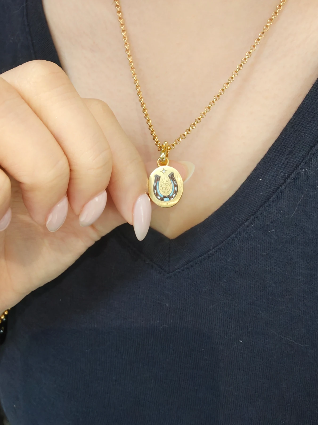 A pet portrait pendant worn close to the collarbone